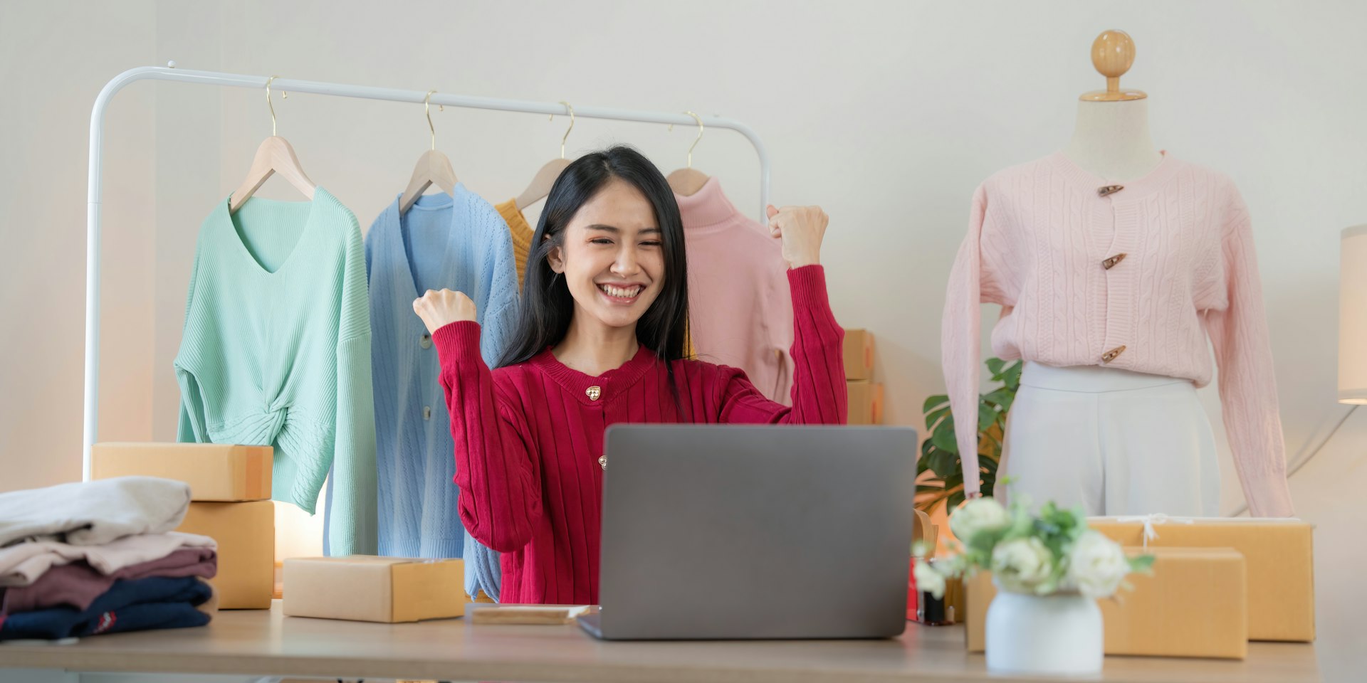 Attractive Woman Discusses Laptop Options with Home Electronics Store Sales Associate. Young Shopper Examines Modern Computer Choices with the Help of a Sales Expert in a Showroom.